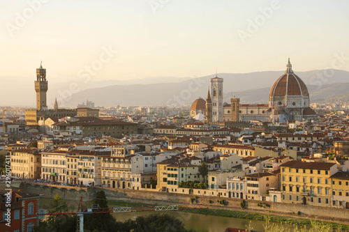 Florence city during golden sunset. Panoramic view of the river Arno with Palazzo Vecchio palace and Cathedral of Santa Maria del Fiore (Duomo), Florence, Italy.