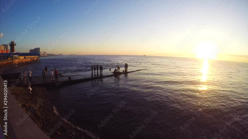 Timelapse of Vladivostok quay and many people coming on pier to take pictures and enjoy of sunset above the sea. Russia Timelapse of Vladivostok quay and many people coming on pier to take pictures and enjoy of sunset above the sea. Russia