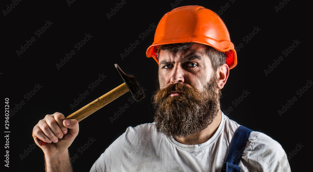 Hammer hammering. Builder in helmet, hammer, handyman, builders in hardhat.  Bearded builder isolated on black background. Bearded man worker with  beard, building helmet, hard hat Stock Photo | Adobe Stock