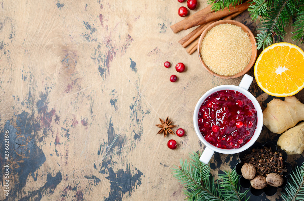 Cranberry sauce with ingredients on a wooden background. Top view, flat lay, copy space. Cranberry sauce with ingredients on a wooden background. Top view, flat lay, copy space.