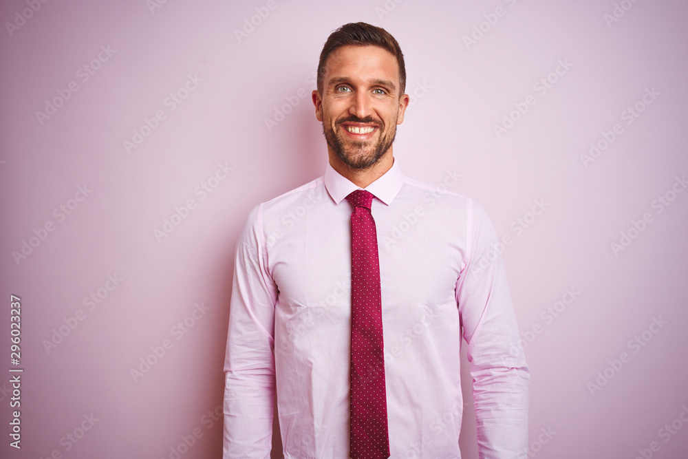 Business man wearing tie and elegant shirt over pink isolated background with a happy and cool smile on face. Lucky person. Business man wearing tie and elegant shirt over pink isolated background with a happy and cool smile on face. Lucky person.