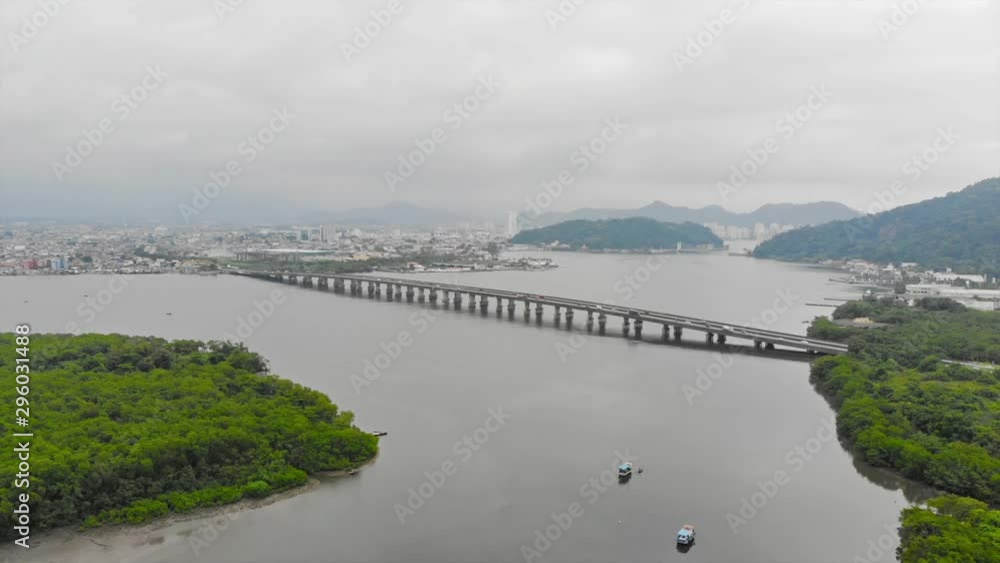 Top Aerial View Of Fishing Boats Near Island Full Of Trees And Bridges Full Of Vehicles - Forwards Top Aerial View Of Fishing Boats Near Island Full Of Trees And Bridges Full Of Vehicles - Forwards