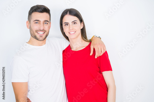 Young beautiful couple in love hugging over white isolated background