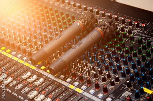 Фотография Microphone placed on the sound mixer with orange flare at the audio control room