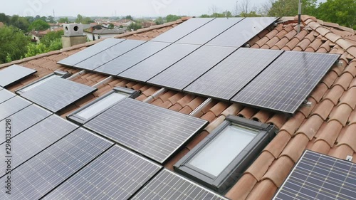 solar energy panels installed on home rooftop, slow parallax circle aerial shot of domestic photovoltaic panel. Sustainable and renewable source of clean energy icon