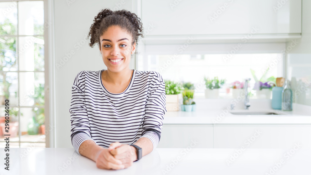 Beautiful african american woman with afro hair wearing casual striped sweater with a happy and cool smile on face. Lucky person. Beautiful african american woman with afro hair wearing casual striped sweater with a happy and cool smile on face. Lucky person.