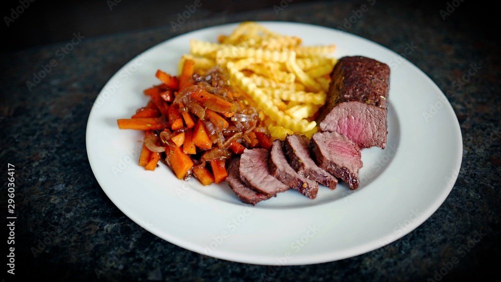 delicious fillet from venison with vegetables and fries delicious fillet from venison with vegetables and fries