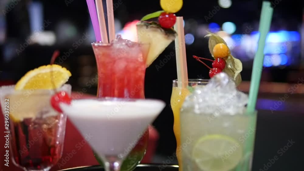 A few colorful alcohol drinks and cocktails in various glasses on blurred, bokeh background in nightclub, bar, disco or pub - mojito, margarita, pina colada, sazerac, manhattan prepared by bartender A few colorful alcohol drinks and cocktails in various glasses on blurred, bokeh background in nightclub, bar, disco or pub - mojito, margarita, pina colada, sazerac, manhattan prepared by bartender