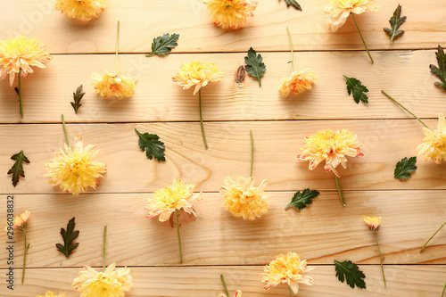 Beautiful chrysanthemum flowers on wooden background © Pixel-Shot