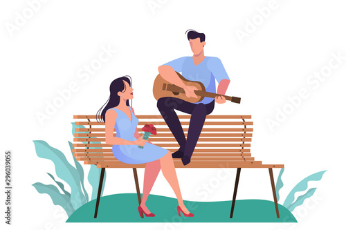 A couple having a date in the park, man playing guitar for woman.