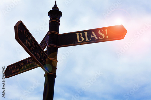 Handwriting text writing Bias. Conceptual photo inclination or prejudice for or against one demonstrating group Road sign on the crossroads with blue cloudy sky in the background