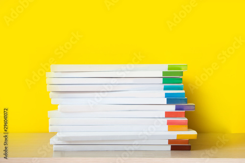 Bild auf Leinwand Stack of colorful books on color background.