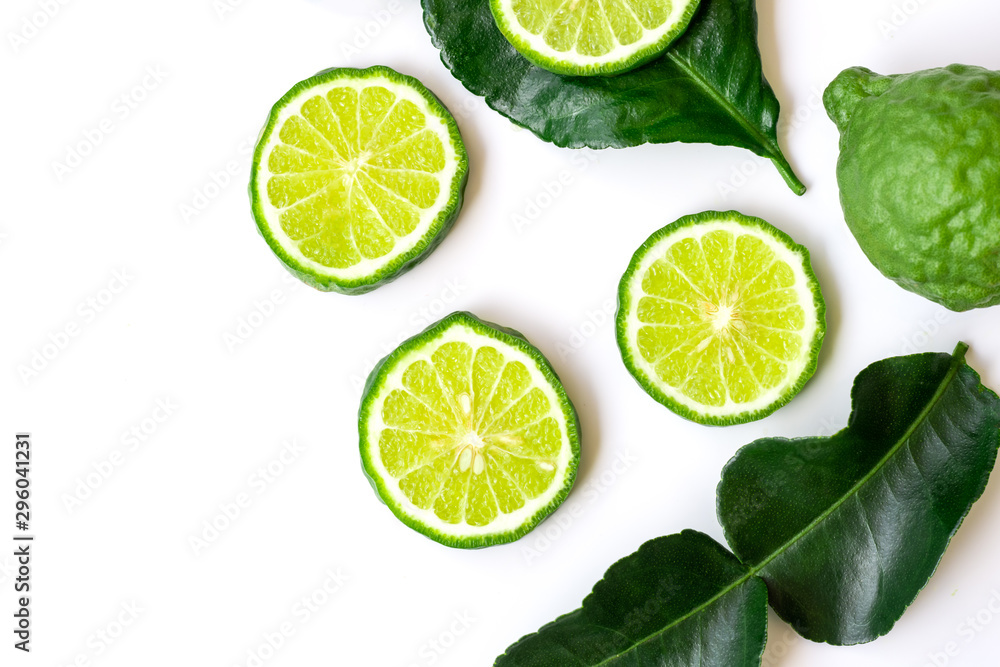 Closeup slices of fresh Bergamot fruits with green leaf isolated on white background .Top view, Copy space for text and content.