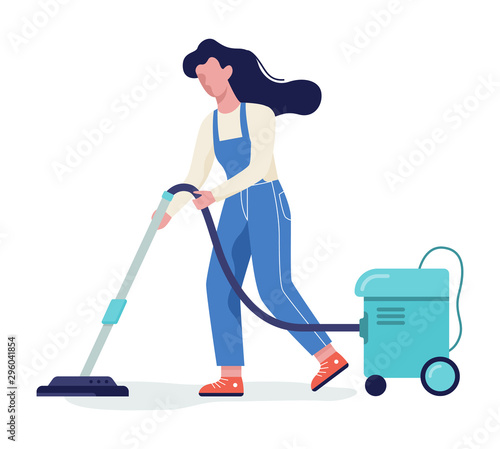 Woman in the uniform cleaning floor using vacuum cleaner.