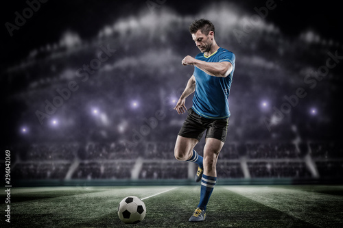 soccer or football player is kicking ball on stadium © romanolebedev