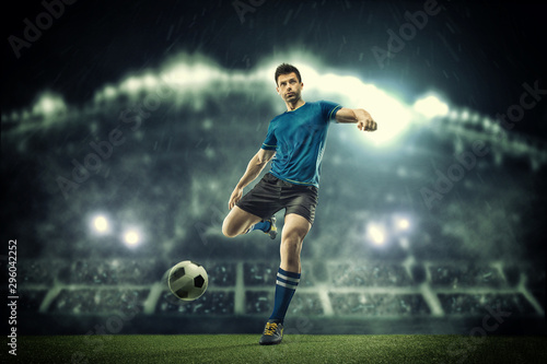 Soccer player in action on night stadium background © romanolebedev