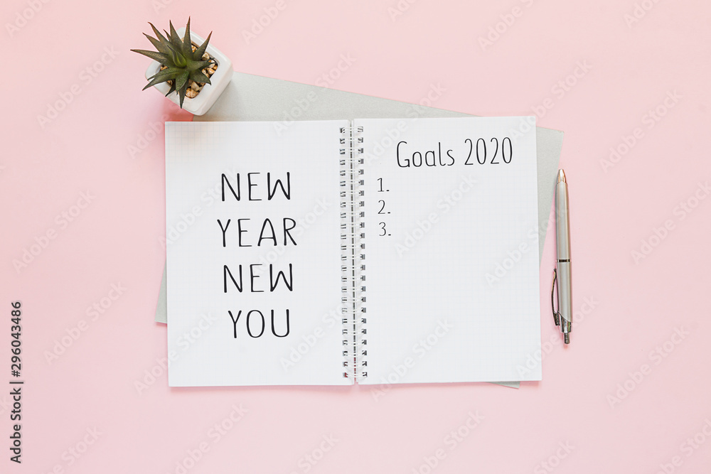 Plakat Top view of a flat lay of desktop and notepads for writing down goals and plans. 2020 New Year's goal, plan, action text on notepad with office accessories. Business motivation, inspiration concept.