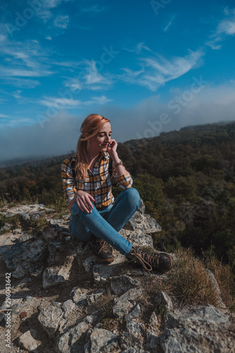 young woman sitting on the rock