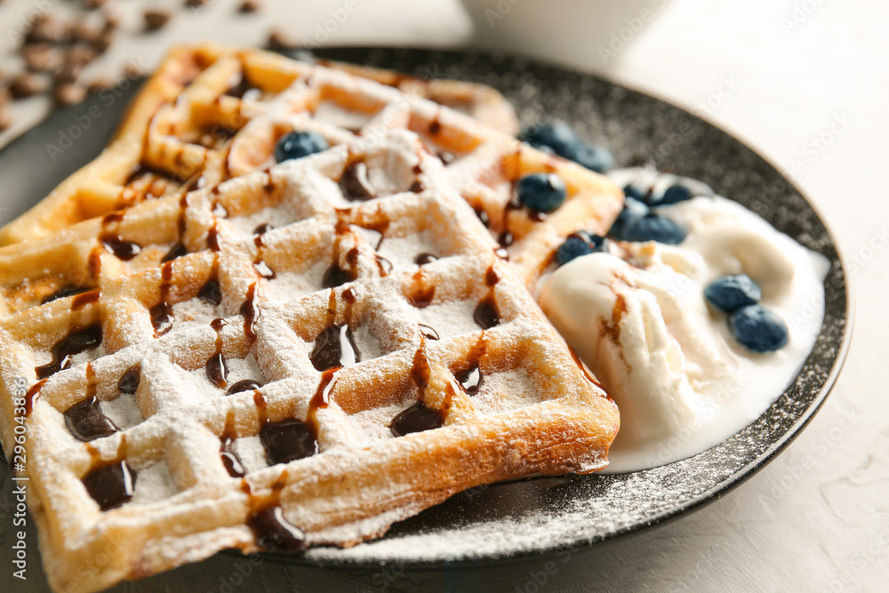 Tasty waffles with chocolate, ice-cream and berries on plate, closeup Tasty waffles with chocolate, ice-cream and berries on plate, closeup