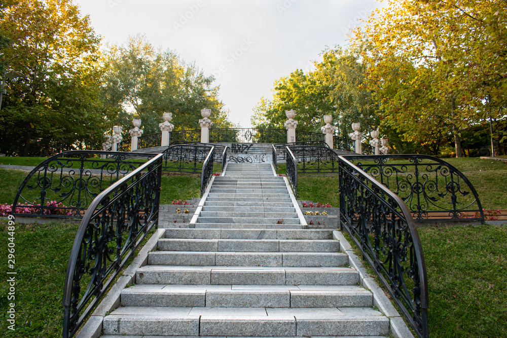 View of a long stairway in the middle of a park, on a beautiful autumn evening.