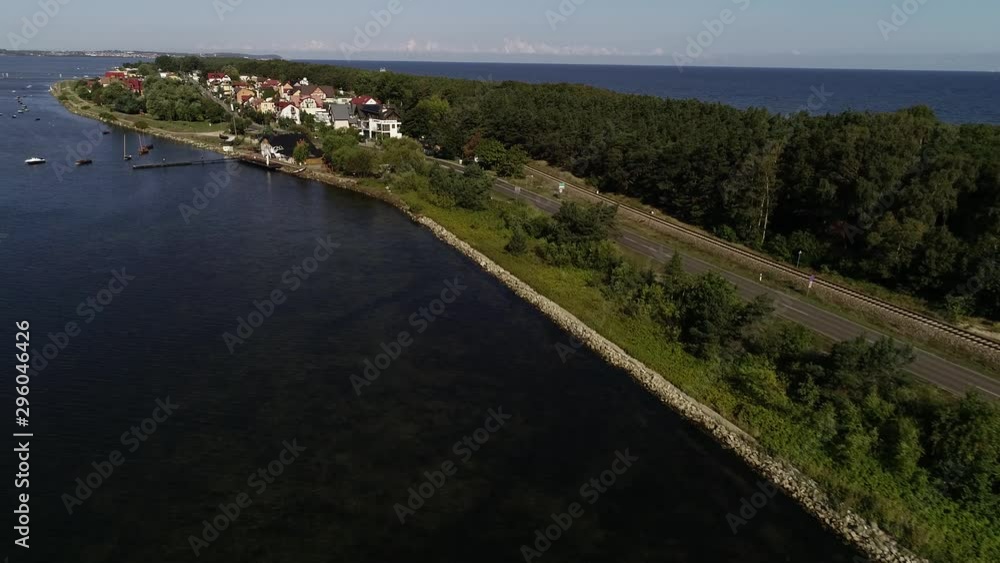 Aerial view of beautiful scenic coast road by the sea. Motorcycle is passing by. Concept: vacation by the sea, motorcycle trip, beautifully located road, famous places in Poland, promontory Aerial view of beautiful scenic coast road by the sea. Motorcycle is passing by. Concept: vacation by the sea, motorcycle trip, beautifully located road, famous places in Poland, promontory