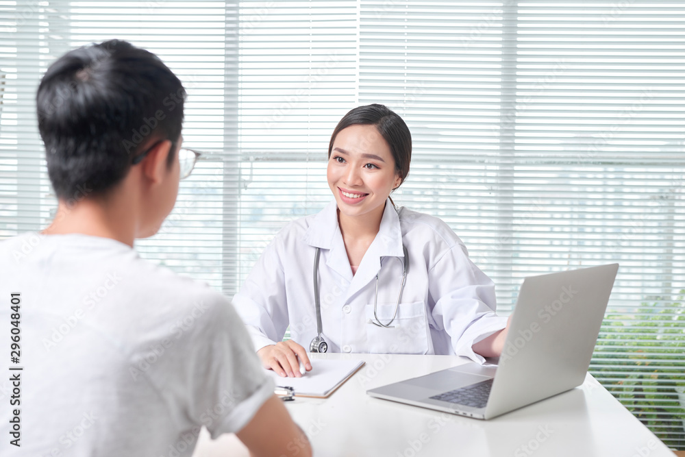 Beautiful female doctor in white medical coat is consulting her patient. Beautiful female doctor in white medical coat is consulting her patient.