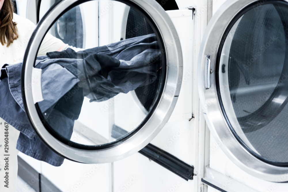 Refilling a Washing machine at laundry Refilling a Washing machine at laundry