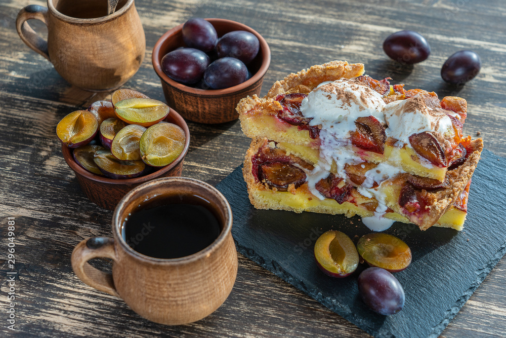 Homemade organic plum pie dessert ready to eat. Plum tart on the old wooden background, close up Homemade organic plum pie dessert ready to eat. Plum tart on the old wooden background, close up
