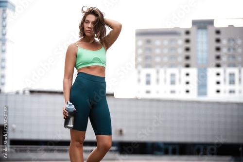Beautiful fitness girl in sportswear resting after workout session. Concept of sport, wellness and health. © opolja