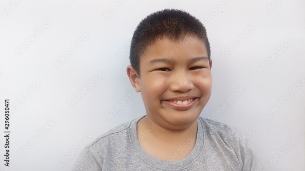 The boy in gray shirt is smiling and has a happy face ... white background The boy in gray shirt is smiling and has a happy face ... white background