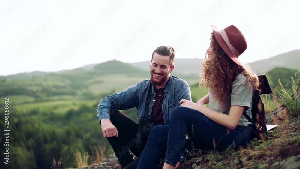 Young tourist couple travellers with hiking in nature, resting. Slow motion. Young tourist couple travellers with hiking in nature, resting. Slow motion.