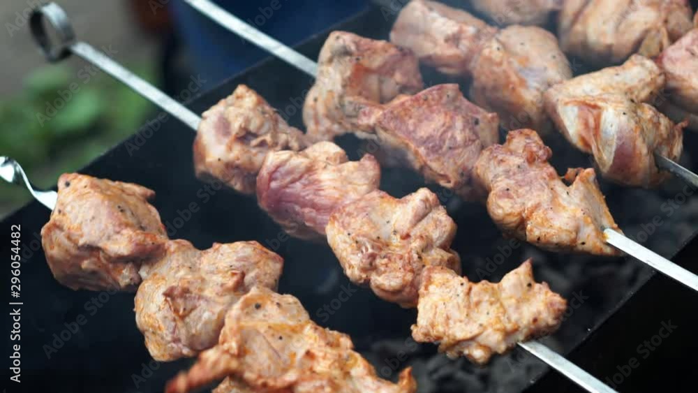 cooking meat on skewers over fire at outdoor, slow motion. Concept of street food, grill cooking meat on skewers over fire at outdoor, slow motion. Concept of street food, grill