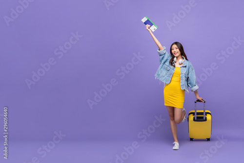 Cheerful young Asian woman tourist ready to fly