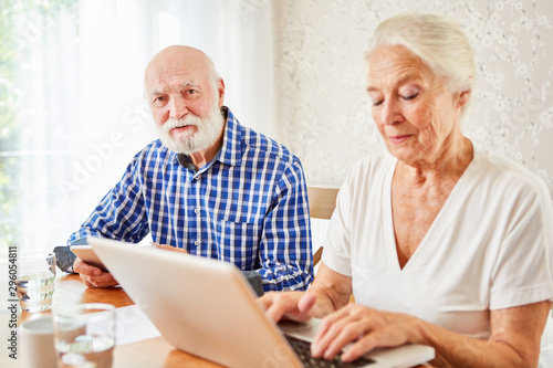 Senior couple using e-learning on laptop