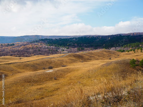 hilly autumn landscape on a cloudy day © Yulia