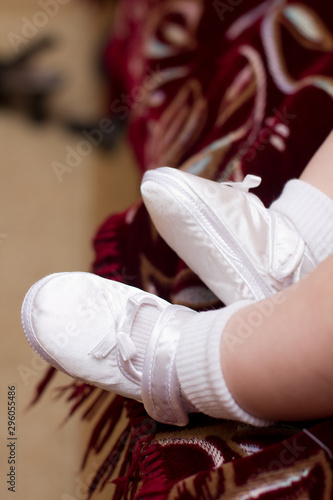White booties on the legs of a newborn