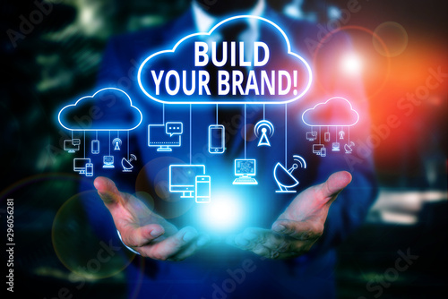 Obraz na płótnie Writing note showing Build Your Brand. Business concept for creates or improves customers knowledge and opinions of product Male wear formal work suit presenting presentation smart device w salonie