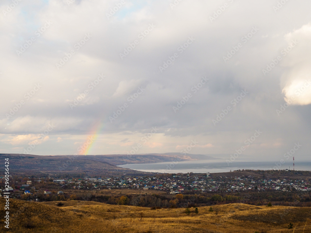 view of the village on a cloudy autumn day. rainbow after the rain view of the village on a cloudy autumn day. rainbow after the rain