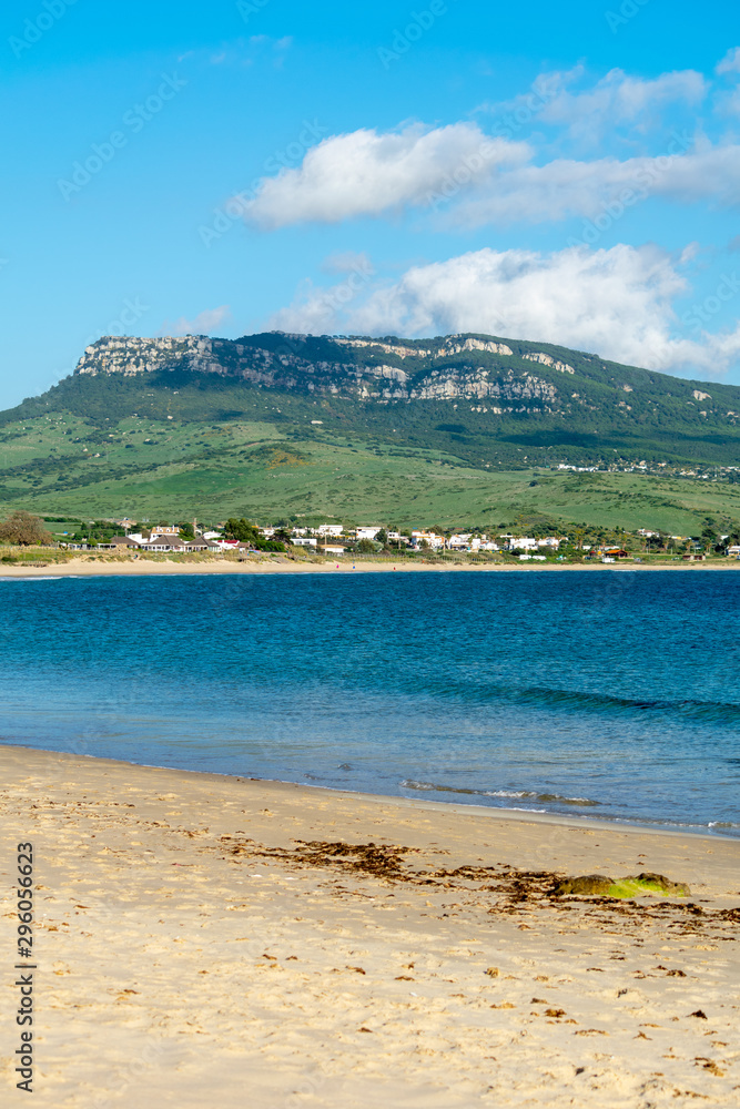 a view of one of the mountain peaks and beach seen from Bolonia beach in Cadiz, spain a view of one of the mountain peaks and beach seen from Bolonia beach in Cadiz, spain