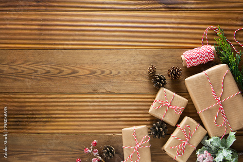 Christmas and winter holidays mock up. Cchristmas gift box with pine cones, fir brances, on brown wood table with copy space. Christmas flat lay, copy space. photo