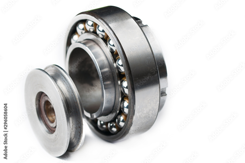 Ball bearing and pulley isolated on white background.Copy space Ball bearing and pulley isolated on white background.Copy space