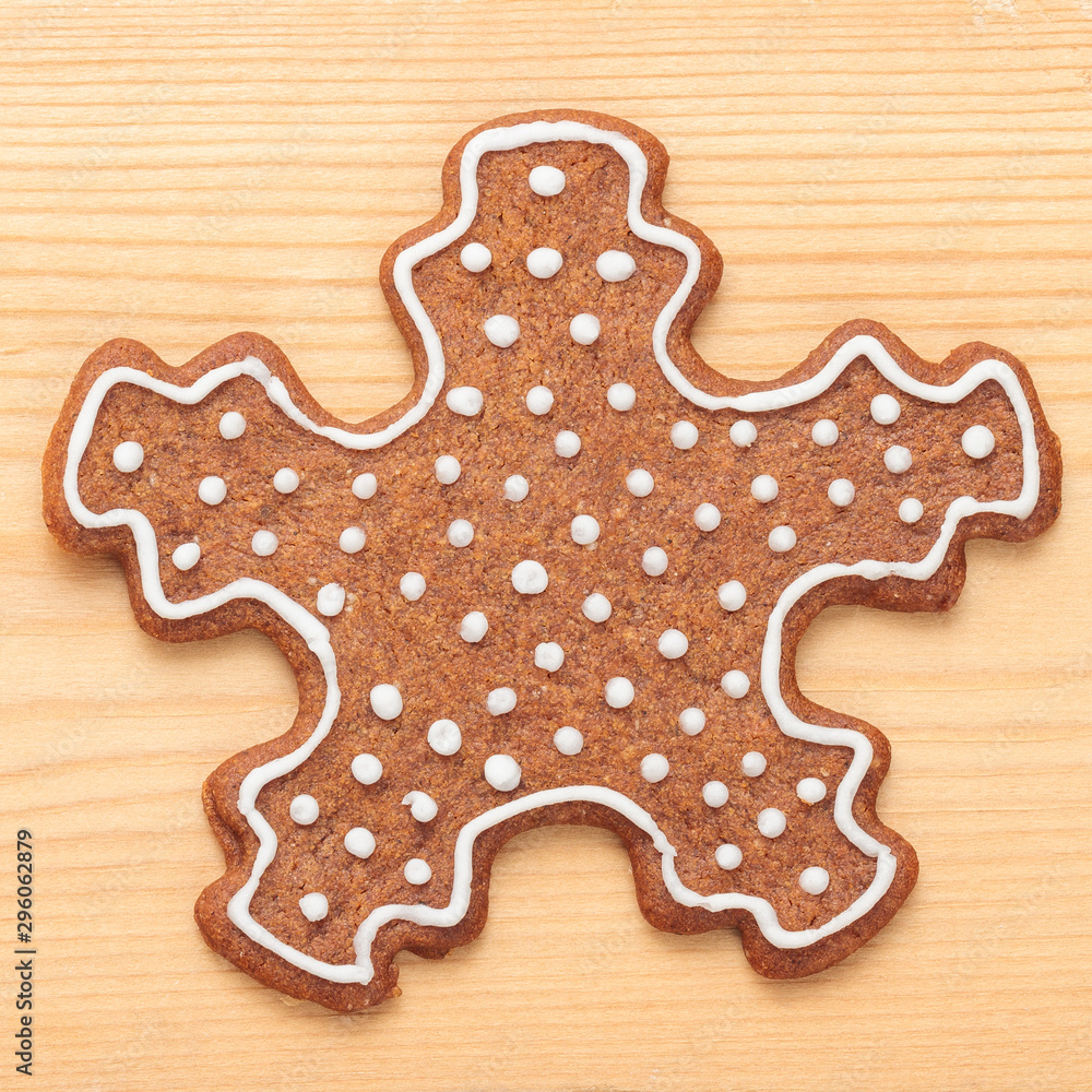 Top view of Christmas gingerbread snowflake biscuit on wooden background Top view of Christmas gingerbread snowflake biscuit on wooden background