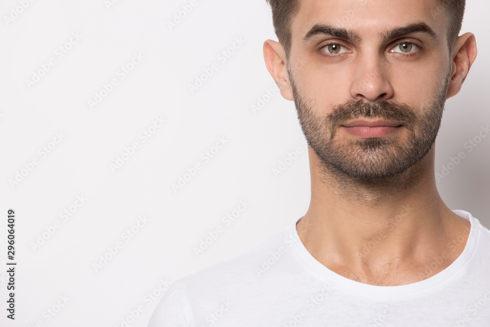 Fototapeta premium Serious caucasian man posing near blank copy space