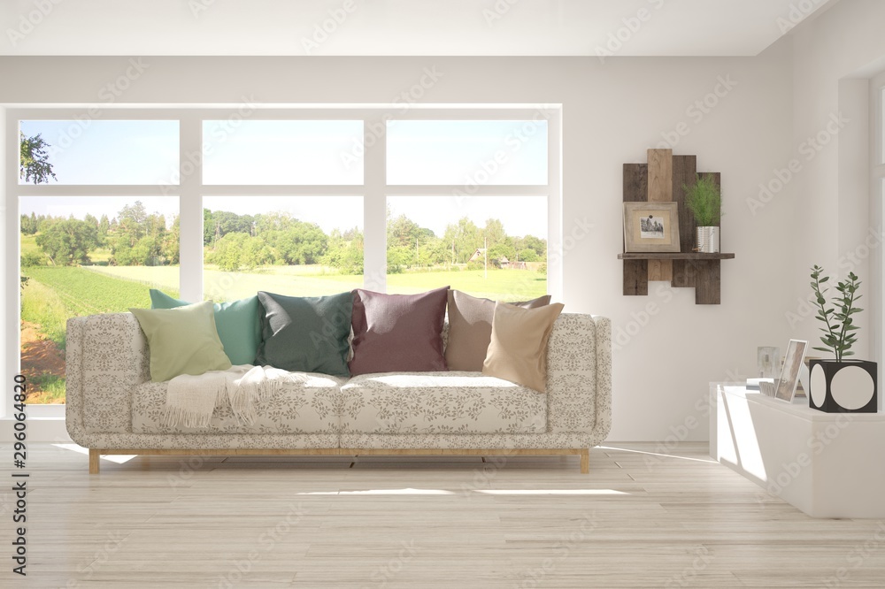 Fototapeta premium Stylish room in white color with sofa and summer landscape in window. Scandinavian interior design. 3D illustration