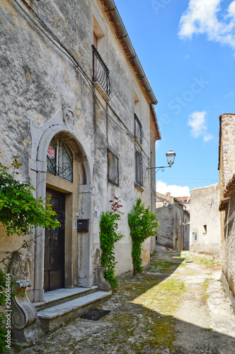 Fototapeta Naklejka Na Ścianę i Meble -  Province of Salerno, Italy, 05/27/2017. A narrow street among the old houses of a mountain village.