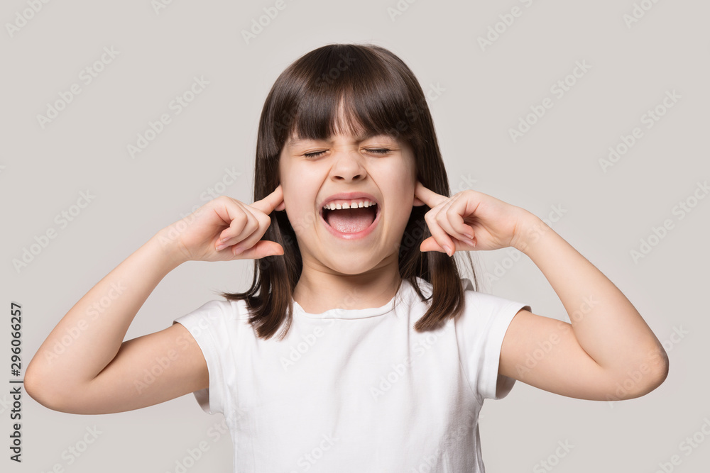 Angry little girl shout tired by loud noise Angry little girl shout tired by loud noise