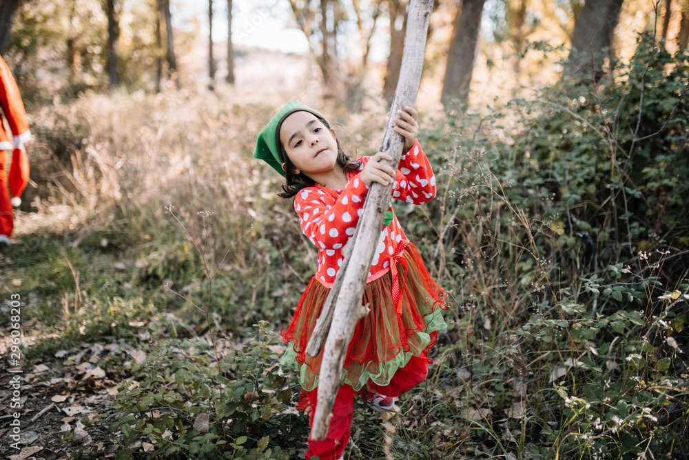 Children disguised to christmas in the forest with their family Children disguised to christmas in the forest with their family
