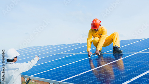 engineer or electrician working on  maintenance equipment at industry solar power;  engineer using thermal imager to check temperature heat of solar panel