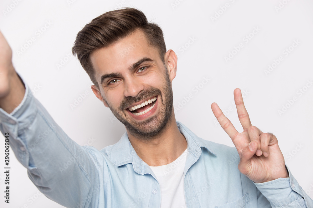 Smiling caucasian man making selfie on gadget Smiling caucasian man making selfie on gadget