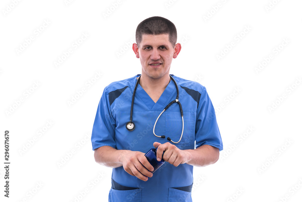 young doctor in blue uniform takes pills from jars isolated on white background young doctor in blue uniform takes pills from jars isolated on white background